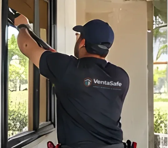 Installer removing an old window